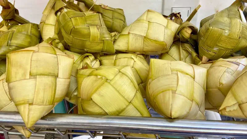 Puso, hanging rice wrapped in coconut leaves, served with meals.