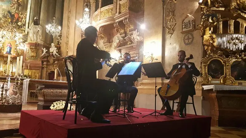 Classical trio playing inside Vienna's historic St. Peter’s Church.