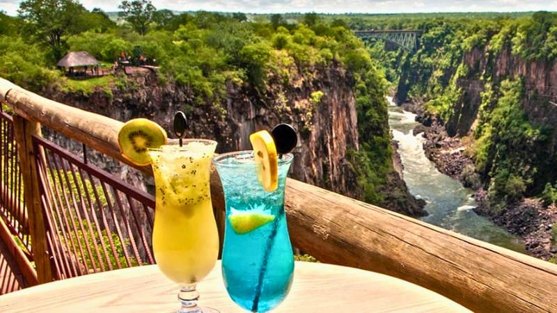 Trip To Victoria Falls Made Easy: Your Step-By-Step Guide 5 Drinks with a scenic view over the gorge, perfect for relaxing after a day at Victoria Falls.