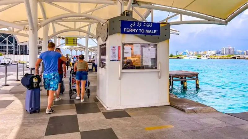 Tourists waiting for the ferry to Male at the terminal, a transportation tip in a best Male island travel guide.