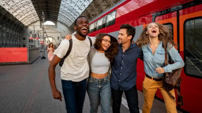 Friends enjoying a day out at a train station, exploring places to visit near Amsterdam by train.