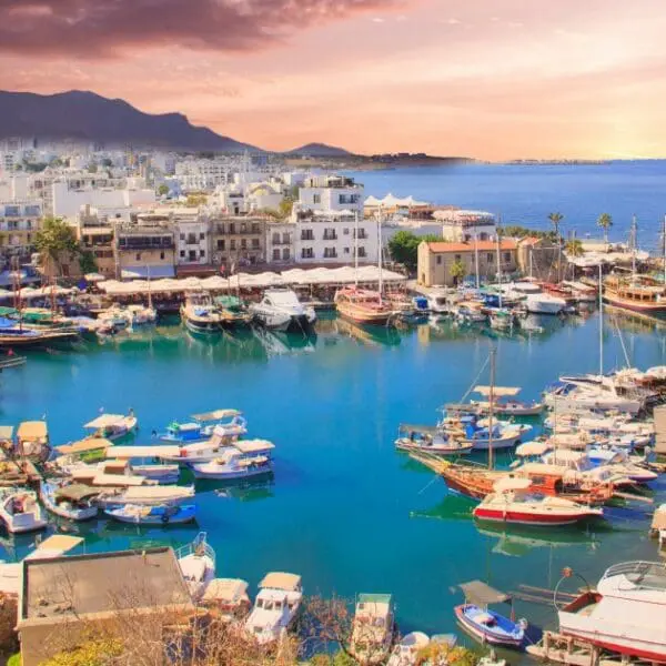Things to do in Nicosia - Boats are docked at the beautiful Kyrenia Harbor with a stunning sunset.
