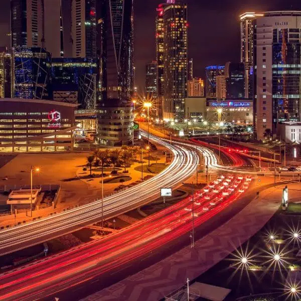 Busy streets and highways at night, showcasing transportation options for getting around Doha.