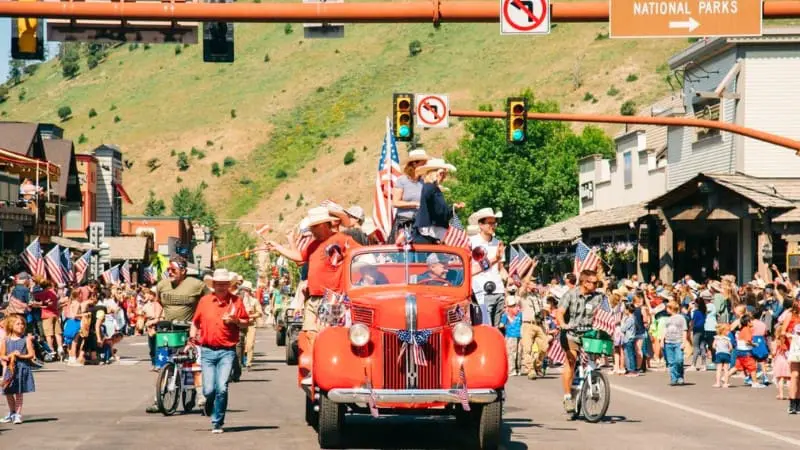 A festive 4th of July parade rolls through a national park town, perfect for 2024 celebrations.