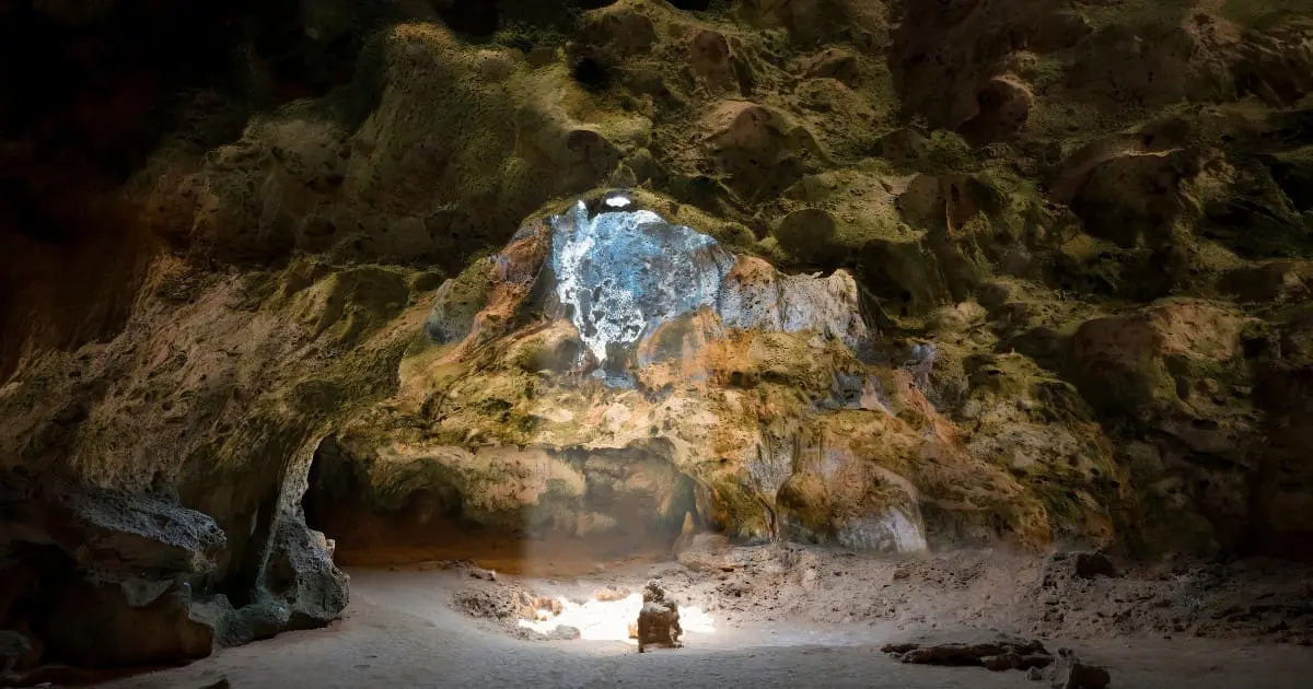 Majestic cave with sunlight streaming through in Arikok National Park.