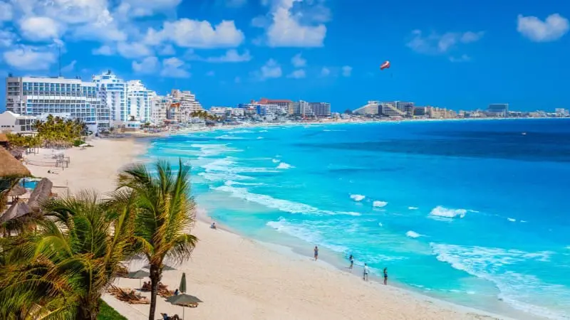 Playa Langosta is a vibrant beach with palm trees, clear water, and a peaceful vibe.