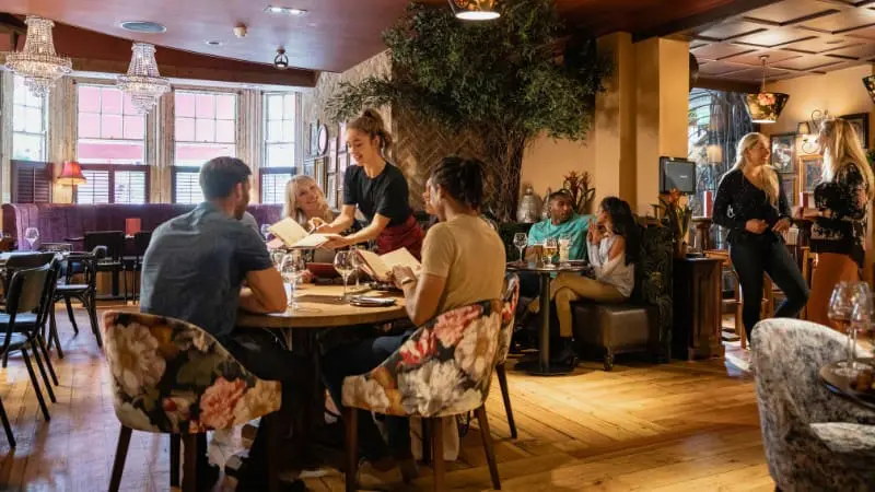 Tourists enjoying a meal at a cozy restaurant in El Calafate Argentina.