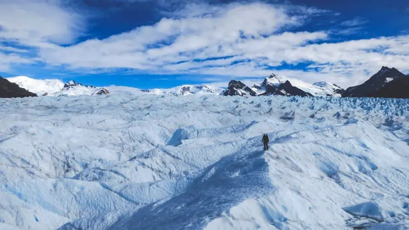 Man trekking on the expansive Perito Moreno Glacier in El Calafate Argentina.