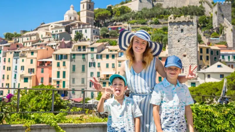 Happy mother and children enjoying the sights of an Italian town during a European family vacation.