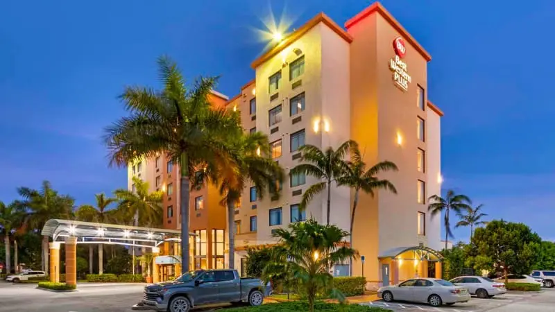 Best Western Plus at night, showcasing its glowing sign, near Miami Cruise Port with free shuttle.