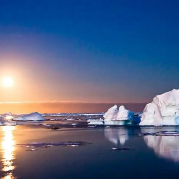Learn how to get to Antarctica and witness stunning sunsets over the icy landscape.