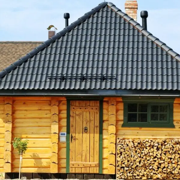 A wooden cabin with a black tile roof serves as a traditional Korean sauna house.
