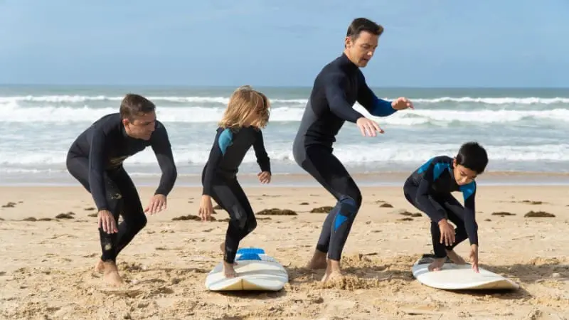 Family enjoying surfing lessons together on the beautiful beaches of Maui.