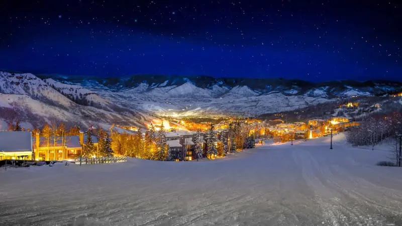 Night skiing in an Austrian mountain village under starry skies