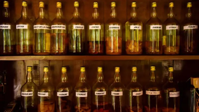 Artisanal Belizean fruit liqueurs in bottles, with tropical flavors as unique souvenirs.