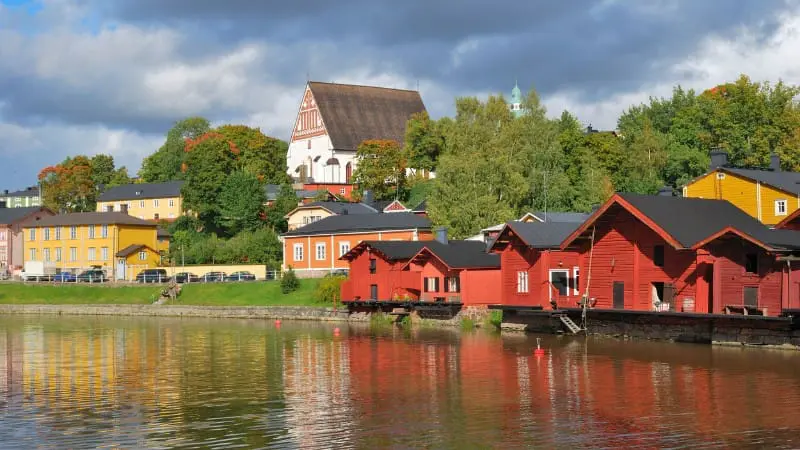 Colorful wooden houses along the water in the old town of Porvoo.