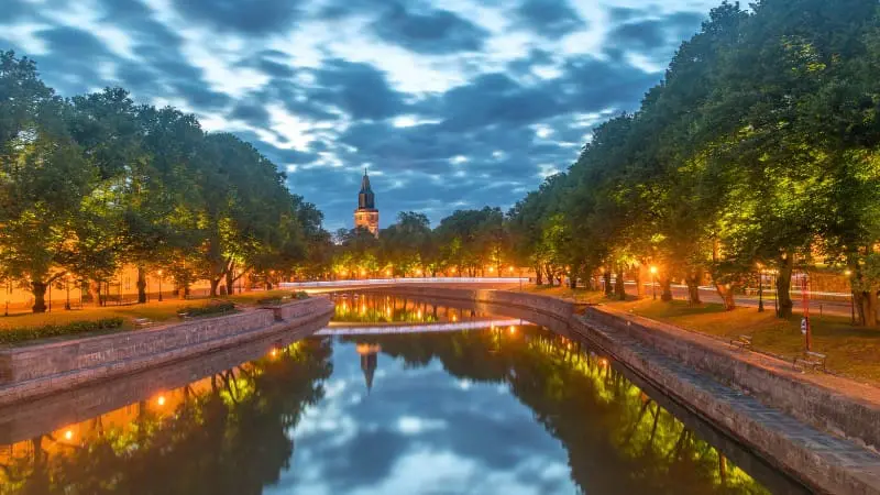Turku's Aura River at twilight, reflecting city lights in this historic Finnish city.