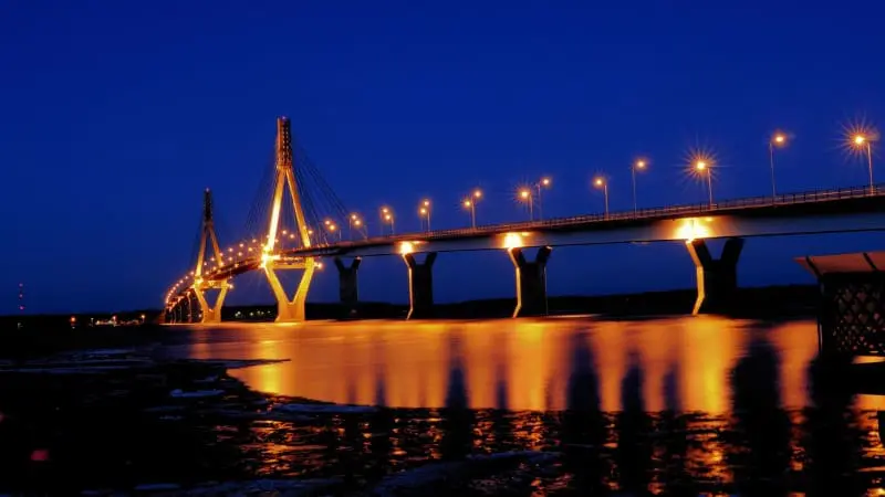 A long bridge lit up with lights at night in Vaasa.