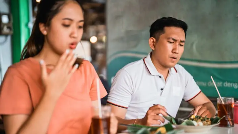 A couple savors Nashville's spicy cuisine, a fun adult activity.