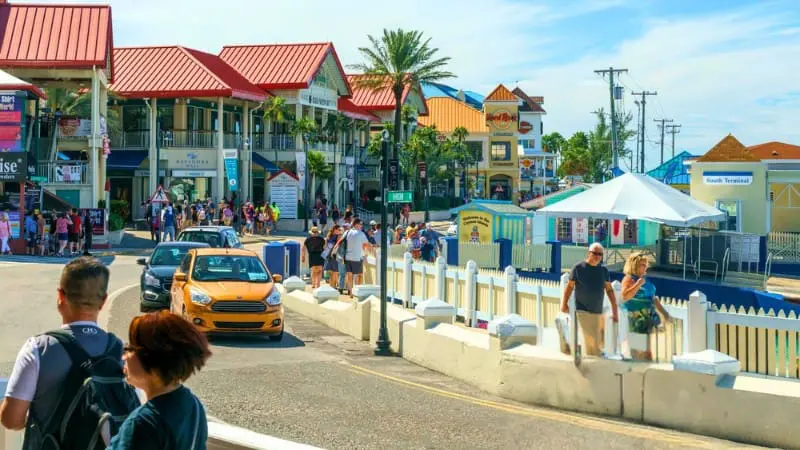George Town Cayman Islands - Shops with red roofs and people on street.