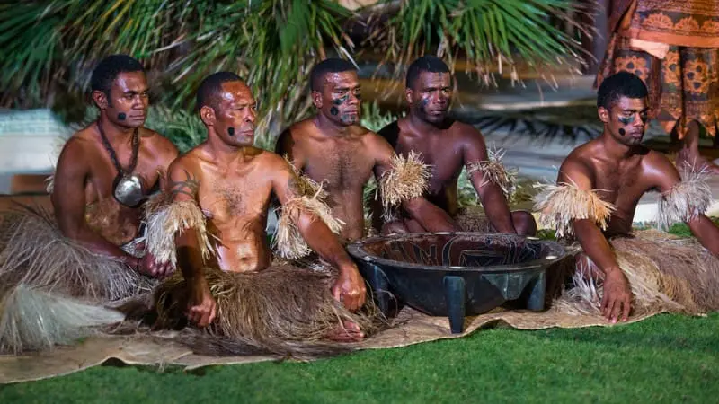 Fijian men performing traditional kava ceremony in Mamanuca Islands.