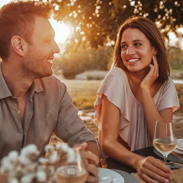 Couple having a dinner at sunset, perfect for romantic getaways near Cleveland.
