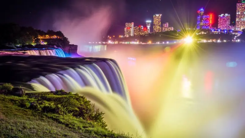 Niagara Falls at night is illuminated with LED lights.
