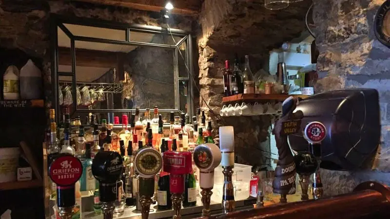 Bistro St-Malo's interior with wooden beams and stone walls.