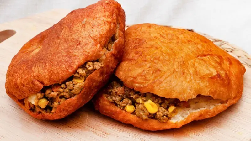 Vetkoek, or fat cakes, are Botswanan fried dough filled with savory meat.