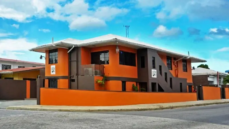 Orange exterior of Culture Crossroads Inn in Port of Spain, Trinidad.