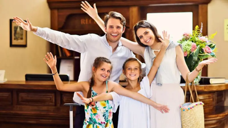 A family checks into their Toronto hotel, excited for the city's fun kid-friendly activities.