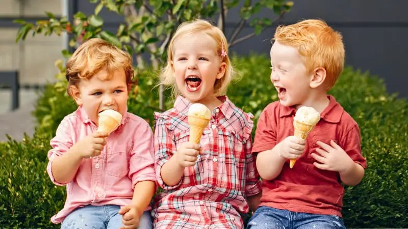 Three kids enjoy ice cream, a perfect treat after exploring Toronto.