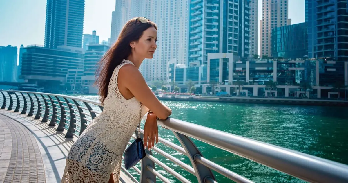 Female tourist in Dubai, aware of dress code penalties.