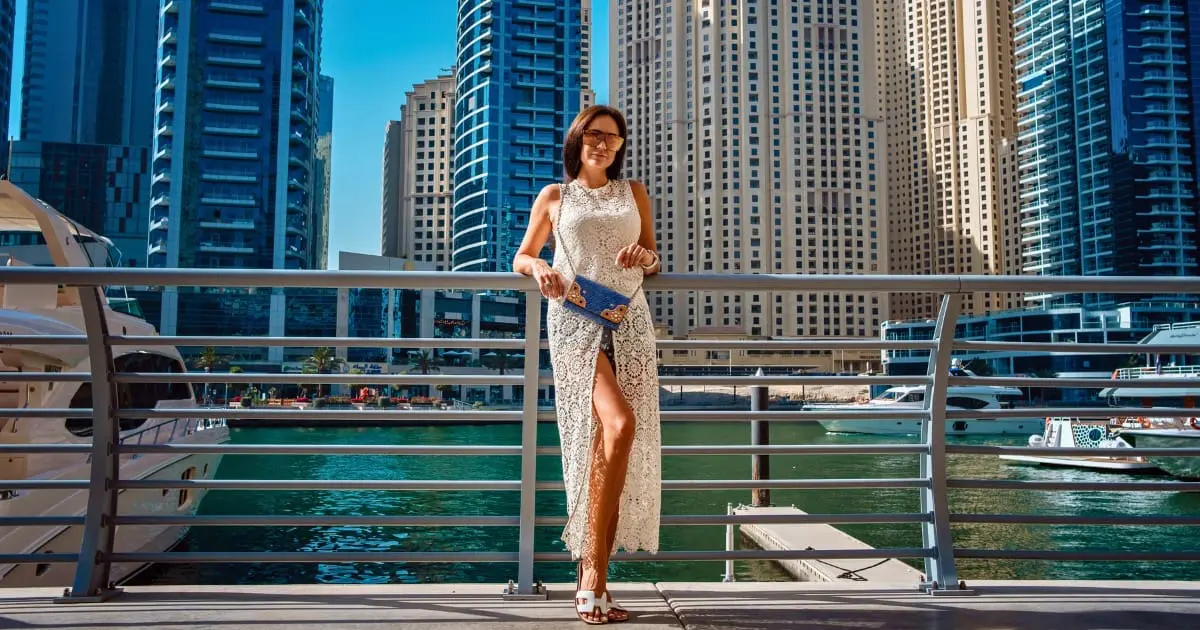 Female tourist in Dubai Marina, dressed as per local customs.