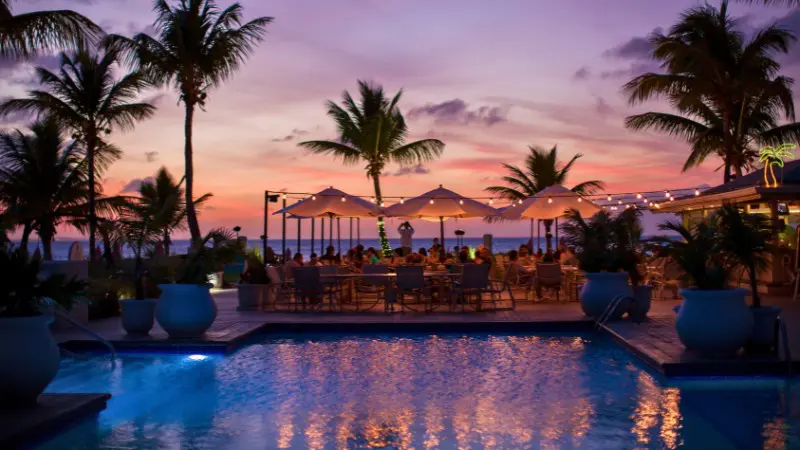 Grand Cayman takes the lead in nightlife with lively beach clubs and local music events.