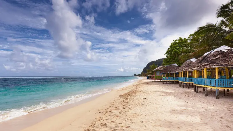 Lalomanu Beach features white sand and clear waters, ideal for swimming.