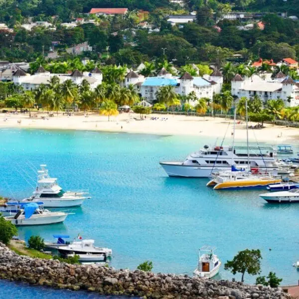 Montego Bay harbor showcases beaches, colorful buildings, and docked boats.