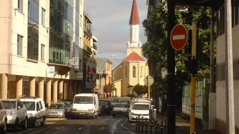 A street in Papeete blends modern buildings with cultural landmarks.