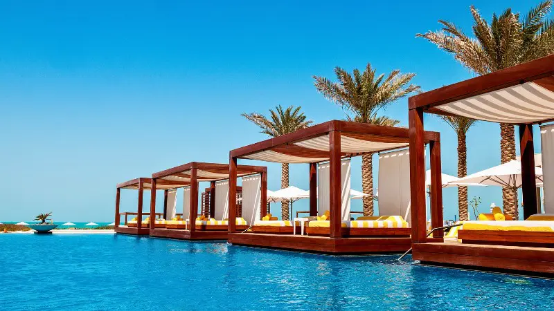 Luxurious poolside cabanas offer privacy for honeymooners in Seychelles resorts.