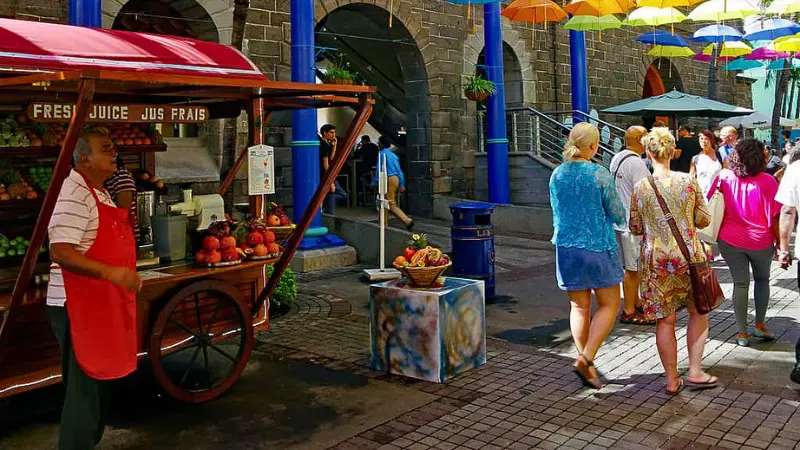 Street food stall in Port Louis with fresh juice and local treats.