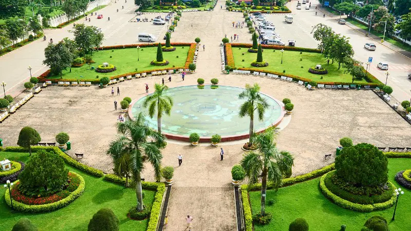 Stroll through Patuxai Park in Vientiane, with beautiful gardens and city views.