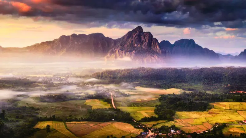 Explore the stunning karst mountains of Vang Vieng on a day trip from Vientiane.