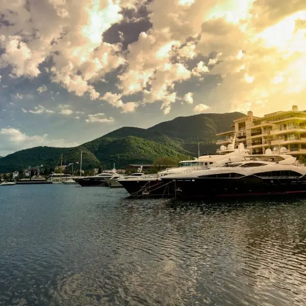 Luxury yachts anchored at Porto Montenegro during a sunset in Tivat.