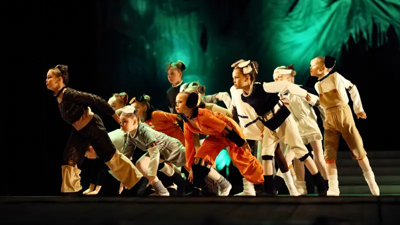 Local children performing in a vibrant cultural event in Tivat.