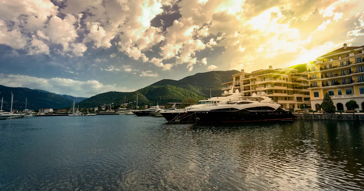 Luxury yachts anchored at Porto Montenegro during a sunset in Tivat.