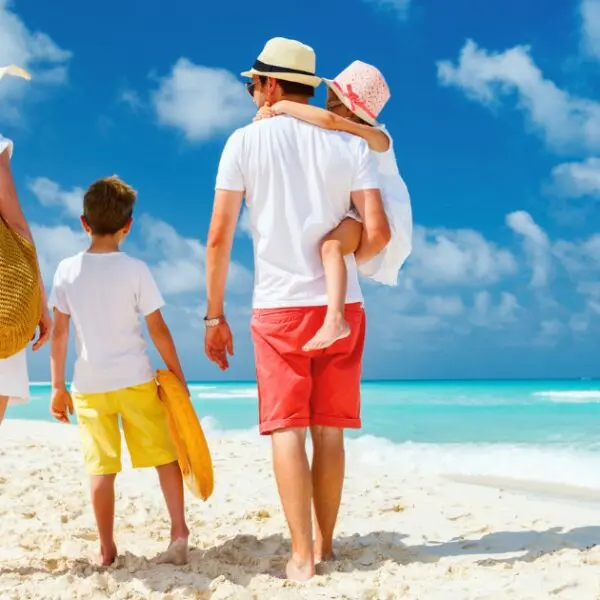 Family enjoying the beach at top family resorts Bahamas offers for vacations.