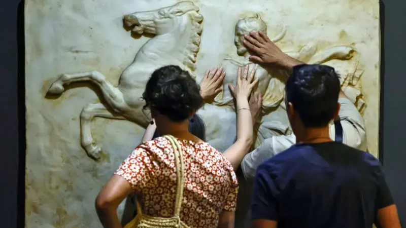 Visitors touch exhibits at Madrid's Typhlological Museum.