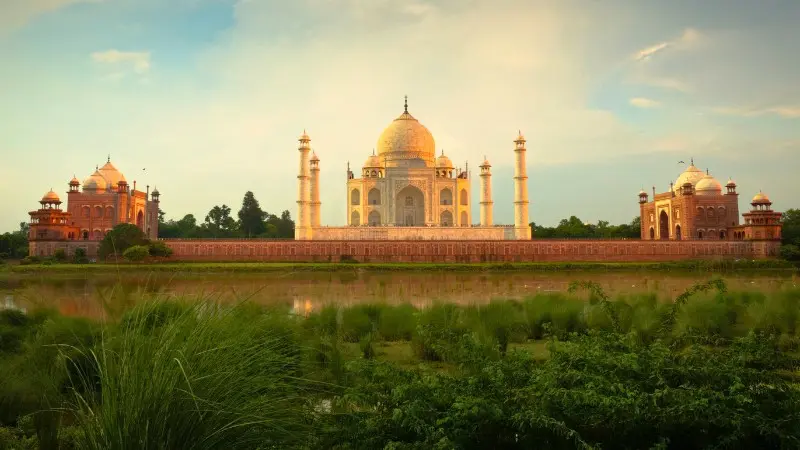 Peaceful Taj Mahal view from Mughal gardens by the Yamuna River.