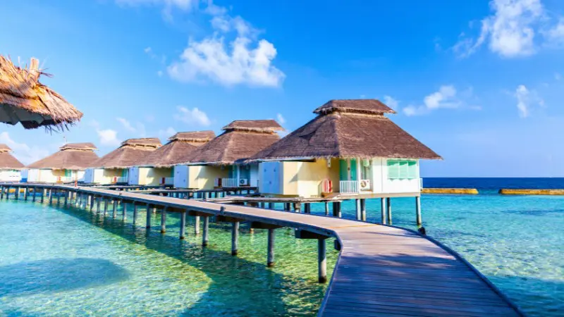 Holiday Inn Kandooma offers budget-friendly overwater villas with serene ocean access.