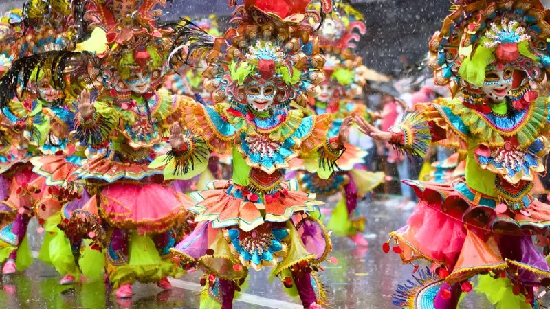Dancers with colorful masks and costumes at MassKara Festival in Bacolod